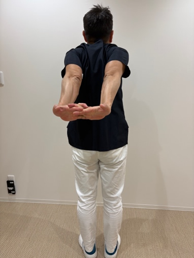 •	両手を背中の後ろで組んで肩甲骨を寄せるストレッチ